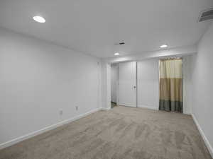 Unfurnished bedroom featuring recessed lighting, carpet floors, and baseboards