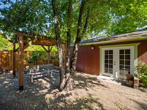 View of yard with french doors and a patio area