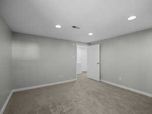 Carpeted spare room with recessed lighting and baseboards