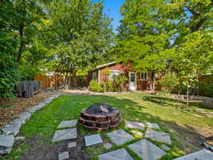 View of yard with an outdoor fire pit