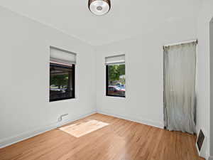 Unfurnished room featuring wood finished floors and baseboards