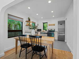 Dining room featuring recessed lighting, baseboards, and light wood finished floors