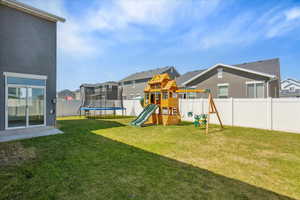 View of play area featuring a trampoline and a residential view