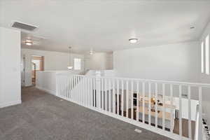 Hallway featuring carpet floors and baseboards