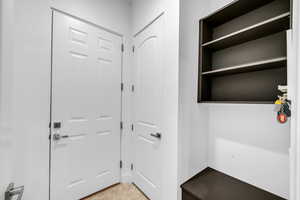 Mudroom with light tile patterned floors