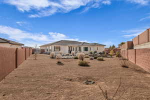 Rear view of property featuring a fenced backyard, a patio area, a tiled roof, and stucco siding