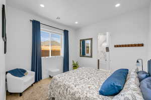 Bedroom with recessed lighting, ensuite bathroom, and baseboards