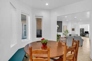 Dining room with recessed lighting and light tile patterned floors