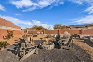Fenced backyard with an outdoor fire pit