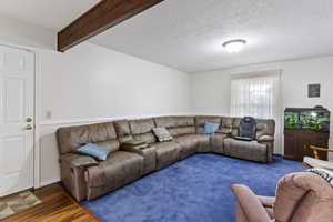 Living room featuring a textured ceiling and wood finished floors