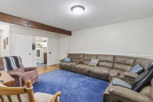 Living room featuring wood finished floors and a textured ceiling