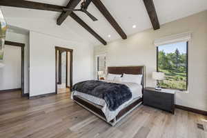 Bedroom with baseboards, light wood-style flooring, multiple windows, and ceiling fan