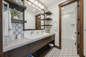 Bathroom with vanity,  shower combination, tasteful backsplash, recessed lighting, and baseboards