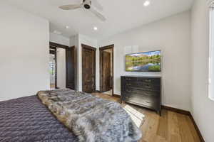 Bedroom featuring wood finished floors, baseboards, recessed lighting, and a ceiling fan