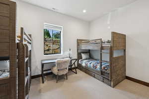 Carpeted bedroom with baseboards and recessed lighting
