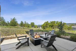 View of patio with an outdoor fire pit