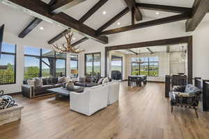Living area with a chandelier, recessed lighting, and hardwood / wood-style flooring