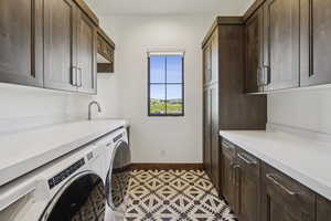 Laundry area featuring cabinet space, independent washer and dryer, and baseboards