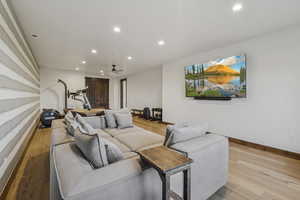 Living area featuring recessed lighting, wood finished floors, a ceiling fan, and baseboards