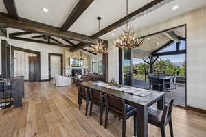 Dining area with a chandelier, baseboards, hardwood / wood-style floors, and recessed lighting
