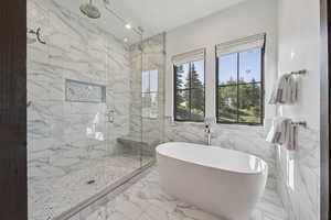 Full bath featuring a marble finish shower, a soaking tub, tile walls, marble finish floors, and recessed lighting