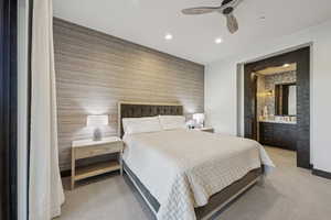 Bedroom with recessed lighting, light carpet, wallpapered walls, an accent wall, and bar