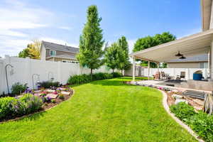 Well-maintained mature yard with landscaping. Established trees and flowerbeds.