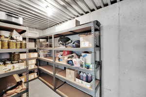 Basement includes a large cold storage room located beneath the front porch. This offers cool temperatures and plenty of shelf space for organized storage. (shelving included)