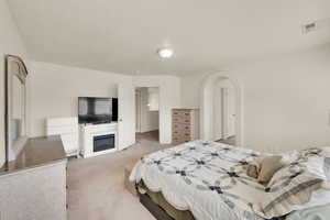 Upstairs Master Bedroom Suite featuring extra sitting area to relax and read. Elegant archway entry to en-suite bathroom.