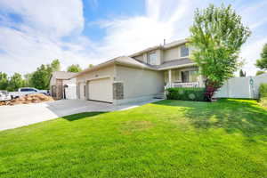 Front of home with covered front porch and mature trees