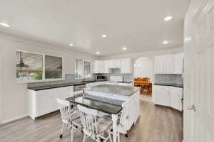 Updated Kitchen with granite countertops, crisp white cabinetry, stainless appliances, with modern fixtures. Open layout with plenty of prep space and storage. Convenient archway access from Dining Room to kitchen.