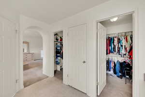 Master Bedroom Suite features an elegant archway leading into the walk-through/ walk-in closets which seamlessly connect into each other, as you enter into the spacious en-suite bathroom.