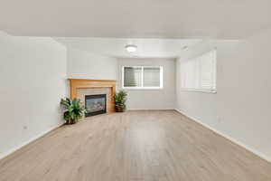 Spacious basement family room for relaxing and entertaining, featuring a cozy gas fireplace to add warmth and ambiance. Brand new vinyl flooring.