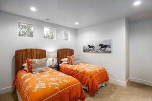 Carpeted bedroom featuring recessed lighting and multiple windows