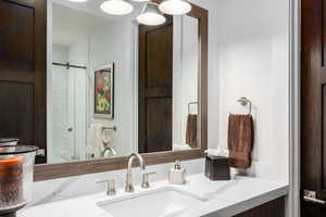 Full bath featuring a shower stall and vanity