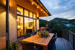 Wooden terrace featuring outdoor dining space and a mountain view