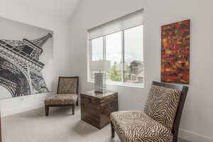Living area featuring carpet flooring and baseboards