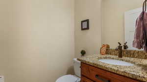 Half bathroom with vanity and toilet