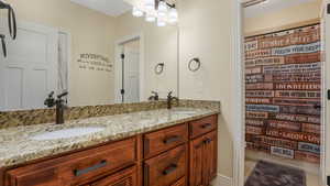 Full bath with double vanity, tile patterned flooring, and a shower with shower curtain