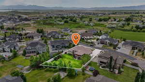 Aerial perspective of suburban area with property boundaries highlighted and a mountain backdrop