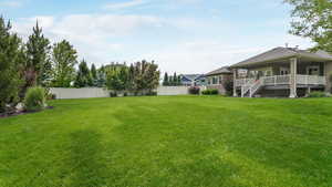 View of yard with a deck and stairs