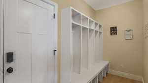 Mudroom featuring baseboards and light wood finished floors