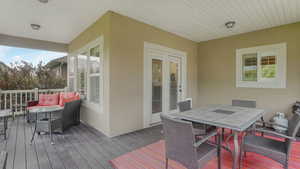Wooden deck featuring outdoor dining area