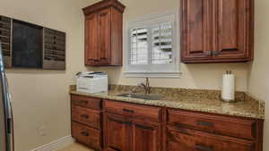 Kitchen featuring a sink and light stone countertops