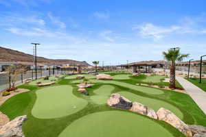 View of community featuring a putting area, a mountain view, and a gazebo