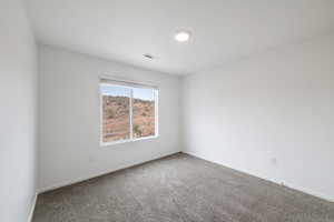 Unfurnished room with carpet and baseboards