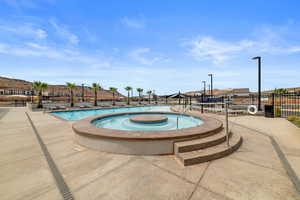 Community pool featuring a community hot tub and a residential view
