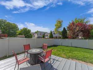 Wooden deck with outdoor dining area and a residential view