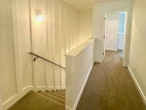 Corridor with carpet and baseboards