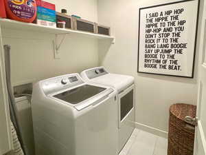 Laundry room featuring separate washer and dryer, light marble finish floors, attic access, baseboards, and recessed lighting